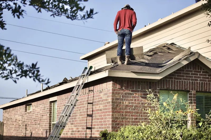 Professional roofer working on a residential roof in North Claremont